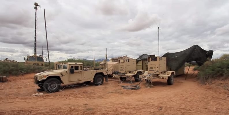 A photo of a military base with Rolatube masts for communication