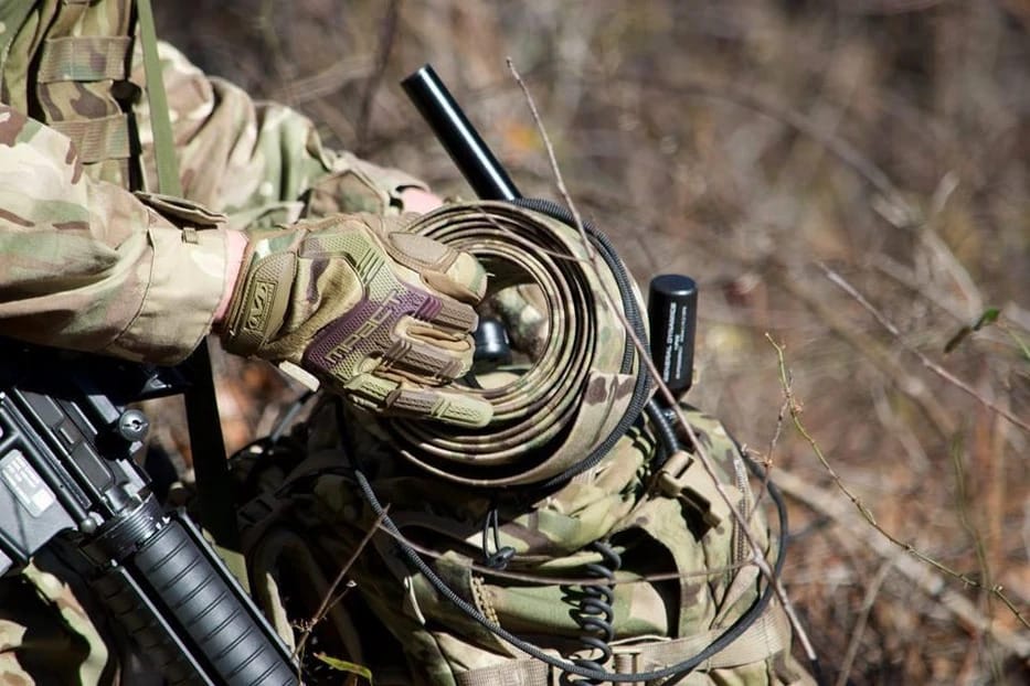 A photo of a soldier deploying a Rolatube mast