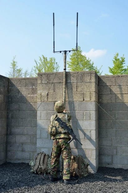 A photo of a soldier using a Rolatube mast for communication