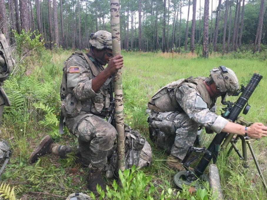 A photo of two soldiers deploying a Rolatube mast