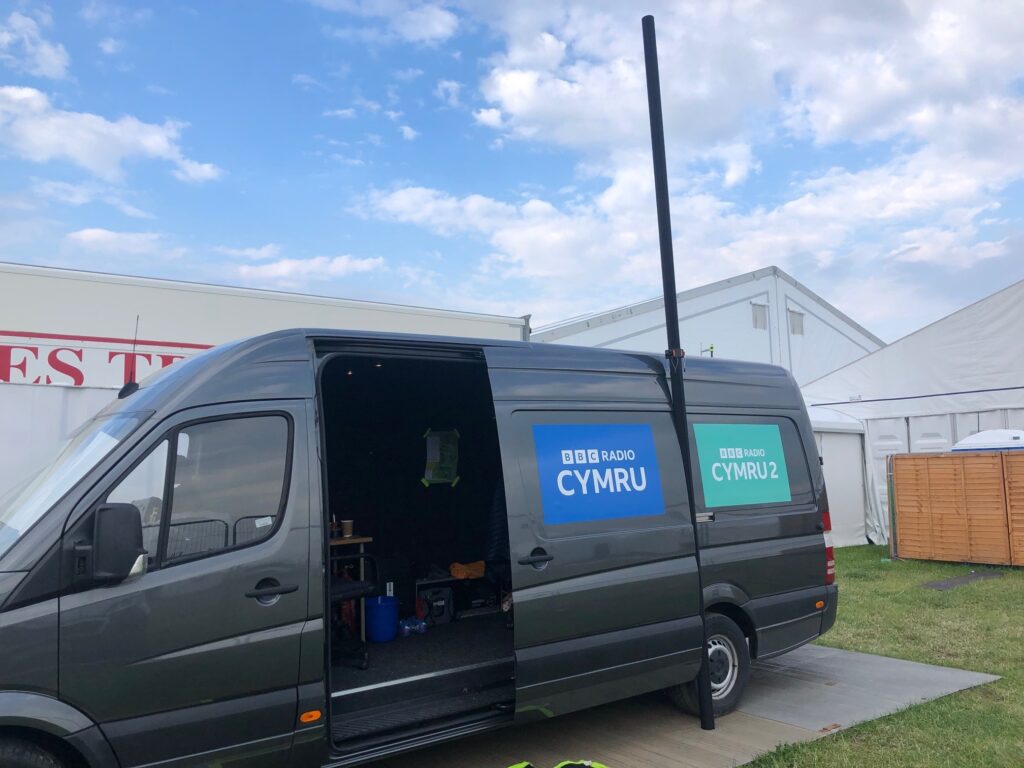 BBC Radio Cymru van with a broadcasting mast attached to the side of the vehicle.