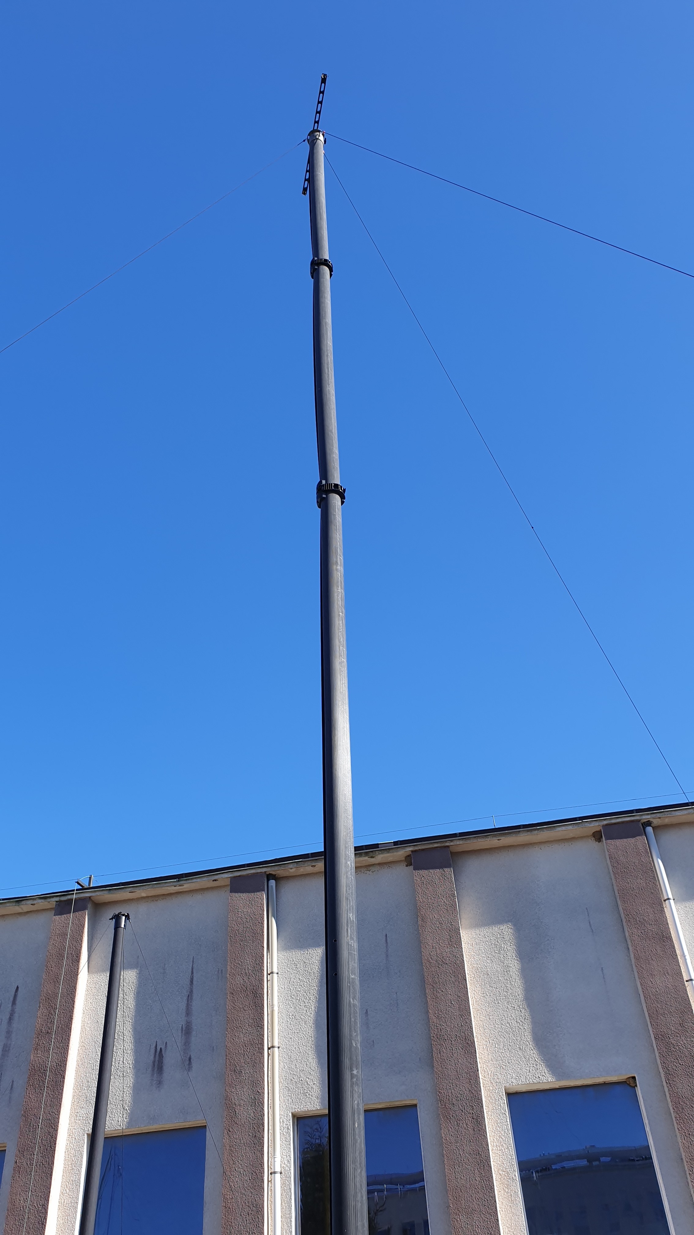 System 100 10m mast deployed at full height against blue sky