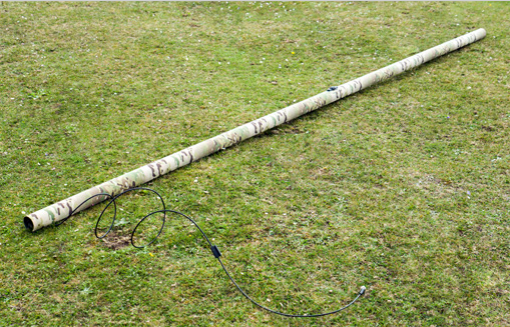 IAM unrolled on grass with cable extended