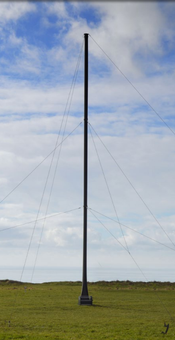 System 100 mast fully deployed in field with guy ropes