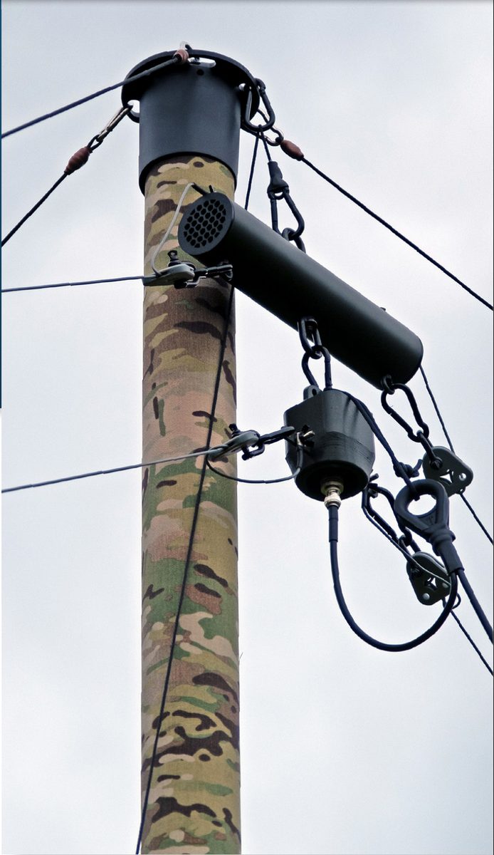 HF Antenna Kit resistor tube and balun mounted at the top of a deployed camouflage mast
