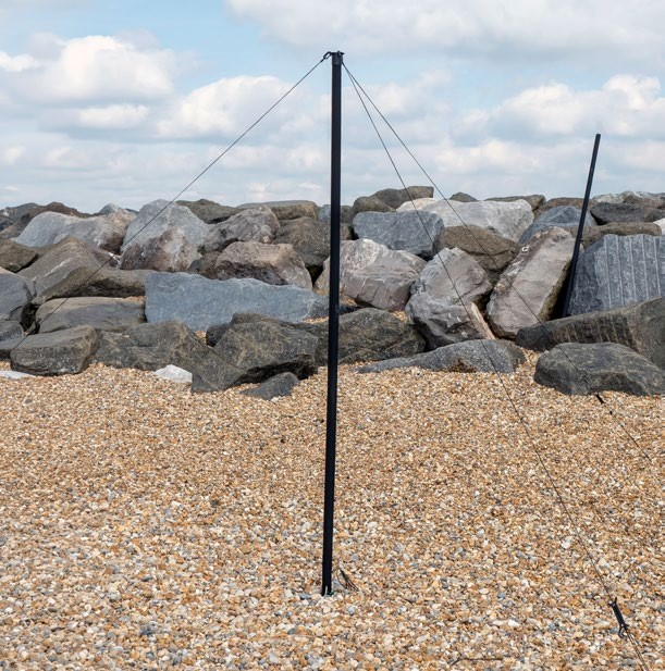 System IAM 3.5m RESQ deployed and guyed on a shingle beach in front of rock armour